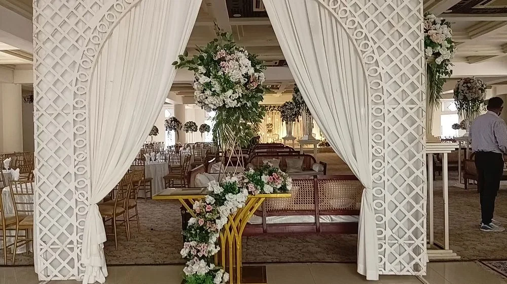 White floral arch marking the hall entrance.